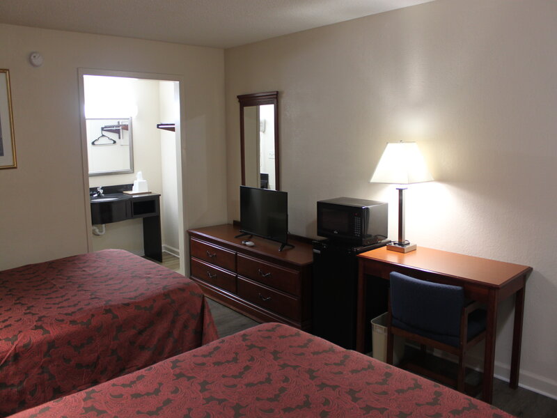 A view of a room with two queen beds at the Travel Inn of Buford